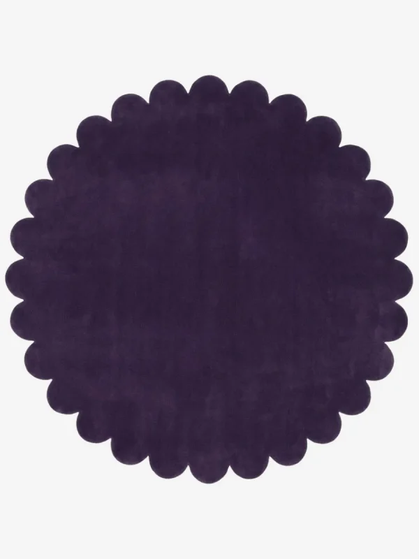 Top down view of the Plum Eclipse circular rug showing the deep violet wool color and scalloped edges.
