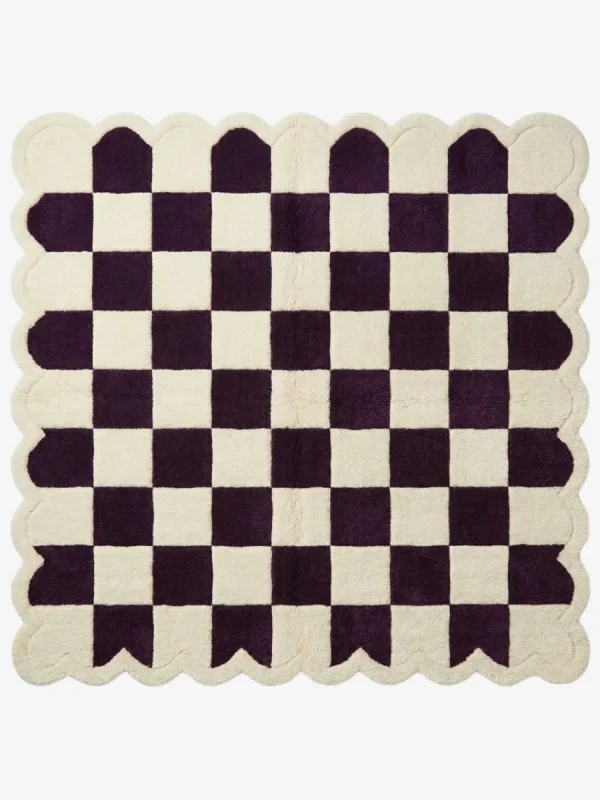 Top-down view of the square Porcelain Rhythm rug, featuring a classic checkerboard pattern in deep plum purple and cream, framed by a matching continuous cream scalloped border.