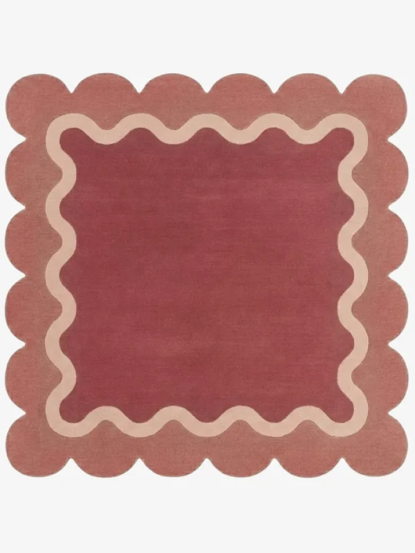 Top down view of the Rose Whisper Square rug featuring a deep rose central field framed by a wavy cream line and a soft pink scalloped border.