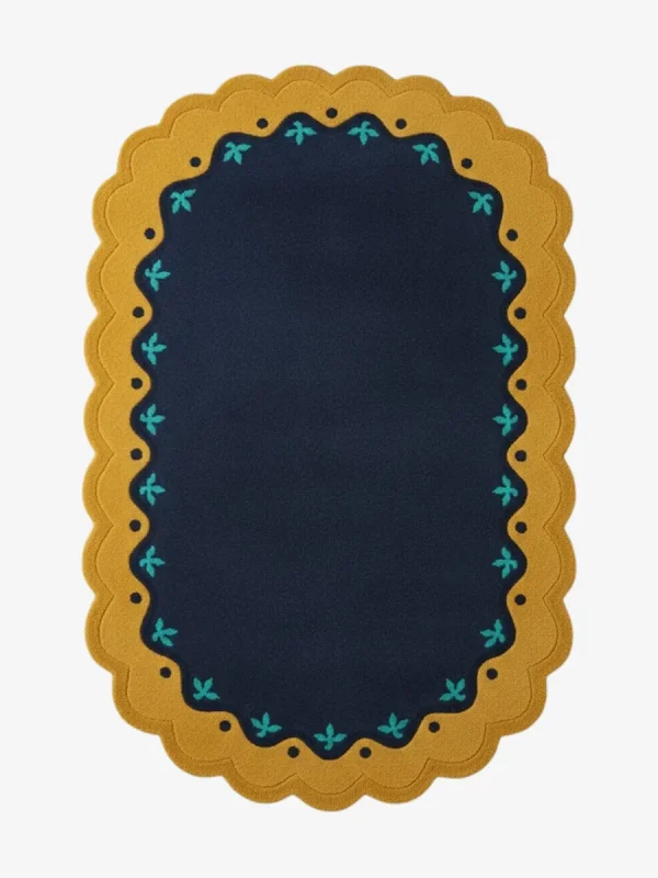 Top down view of the Royal Indigo rug featuring a deep navy blue center framed by a mustard gold scalloped border with delicate teal floral accents.