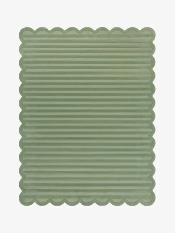 Top down view of the Sage Rhythm rug featuring a solid sage green color with horizontal carved textures and decorative scalloped edges.