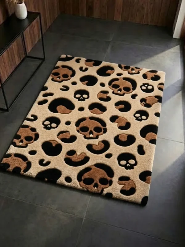 Perspective view of the rectangular Savage Skull Leopard rug styled on a dark slate floor, featuring a tan background with a unique leopard print pattern made of brown and black skulls and spots.