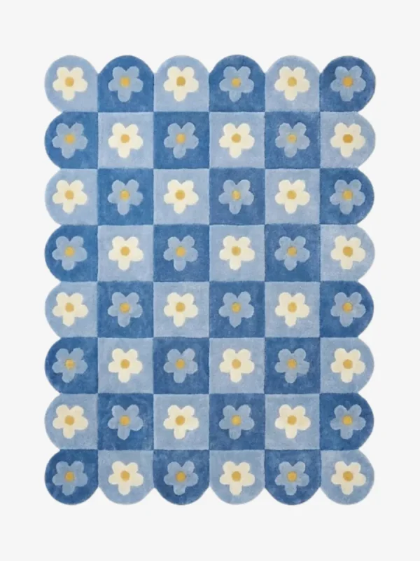 Top down view of the Sky Carousel rug featuring a playful checkerboard pattern in dark and light blue with white daisy flowers in every square.