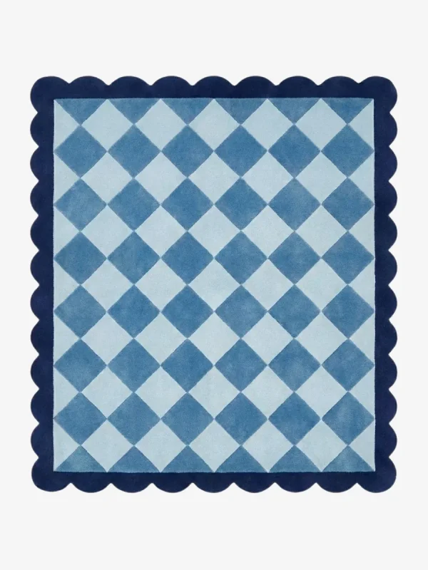 Top down view of the Slate Haven rug featuring a classic diamond checkerboard pattern in soft slate blue and light blue tones, framed by a deep blue scalloped border.