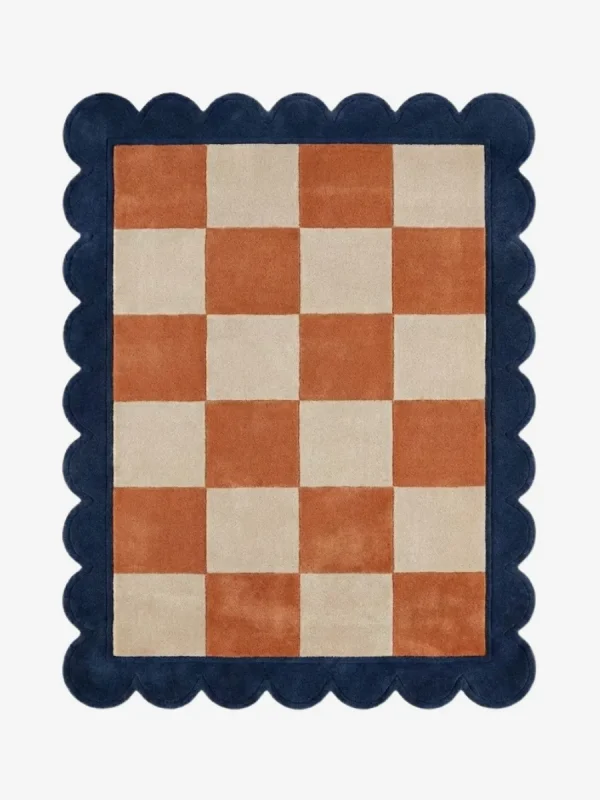 Top down view of the Solace Tide rug featuring a soothing checkered pattern in shades of soft coastal blue and cream wool, finished with custom scalloped edges.