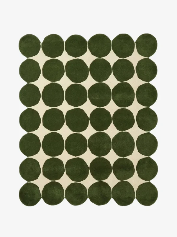 Top down view of the Still Meadow rug featuring a bold geometric pattern of large deep green circles arranged in a grid on a cream wool background.