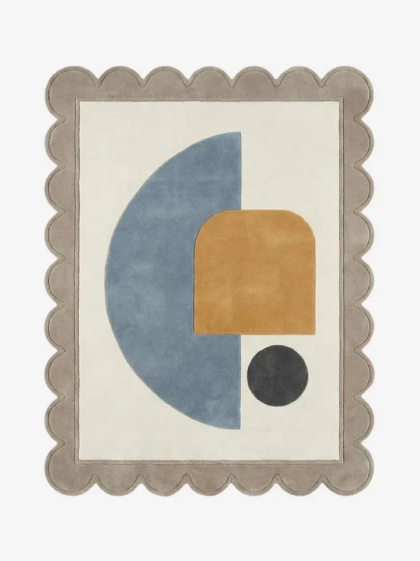 Top down view of the Still Shore rug featuring a calming abstract geometric design with a large blue semi-circle and ochre arch accent on a cream wool background, finished with custom scalloped edges.