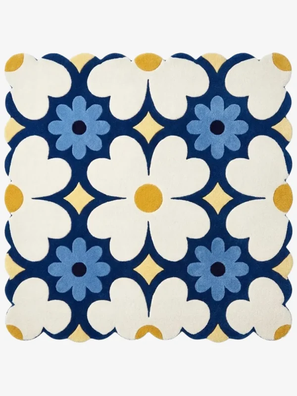 Top down view of the Sun Dot Posy square rug featuring a retro geometric floral pattern with cream and blue flowers on a navy background with scalloped edges.