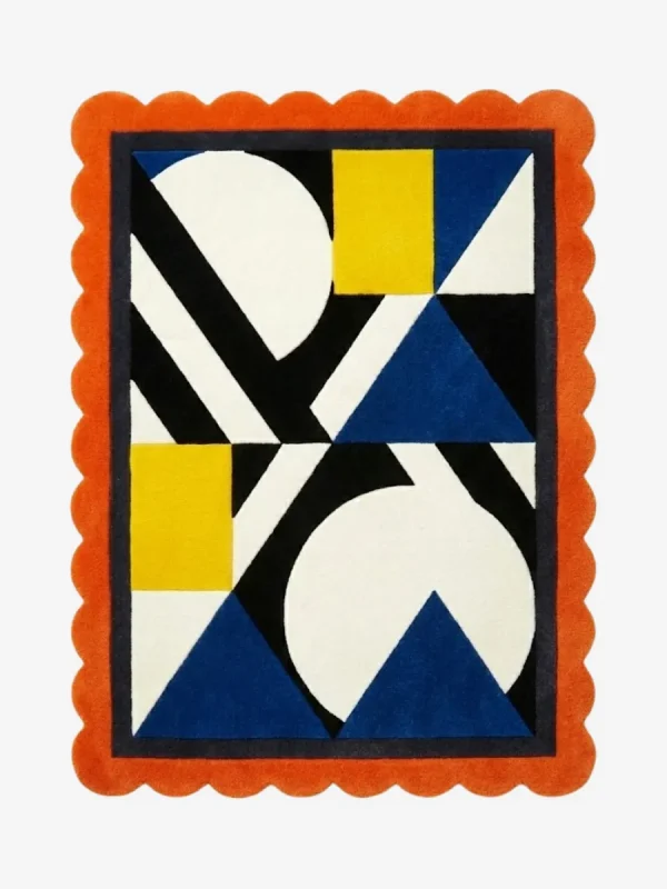 Top down view of the Sunpatch Mosaic rug featuring a bold geometric pattern with blue triangles, yellow blocks, and black and white accents, framed by a vibrant orange scalloped edge.