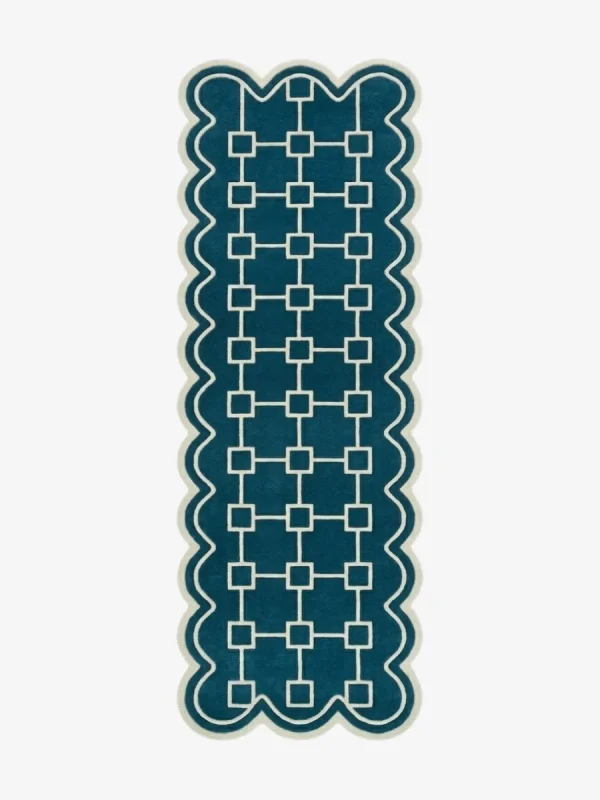 Top down view of the hand-tufted Terenza Coil Runner Rug featuring a rich teal background, a cream geometric square chain pattern, and distinctive scalloped edges.