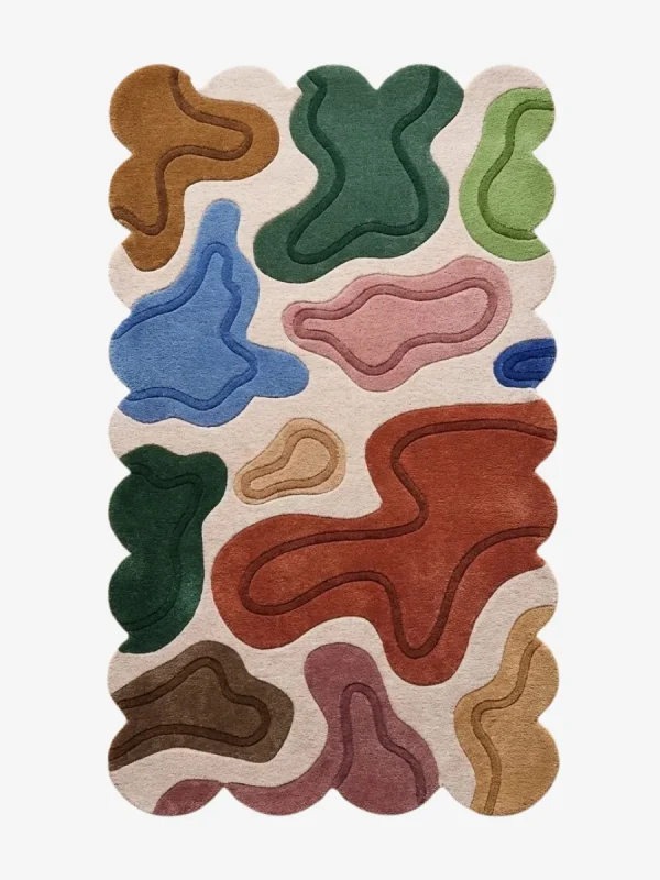 Top down view of the Terra Pebble rug featuring a cream background with distinct organic abstract shapes in terracotta blue green and pink.