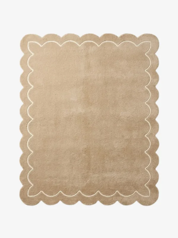 Top-down view of the rectangular Velune Nest rug, featuring a solid warm tan background bordered by a scalloped edge and a delicate, continuous cream inner line mimicking the wavy silhouette.